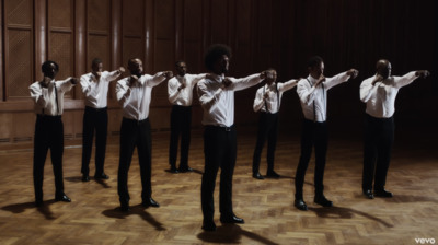 a group of men standing on top of a wooden floor