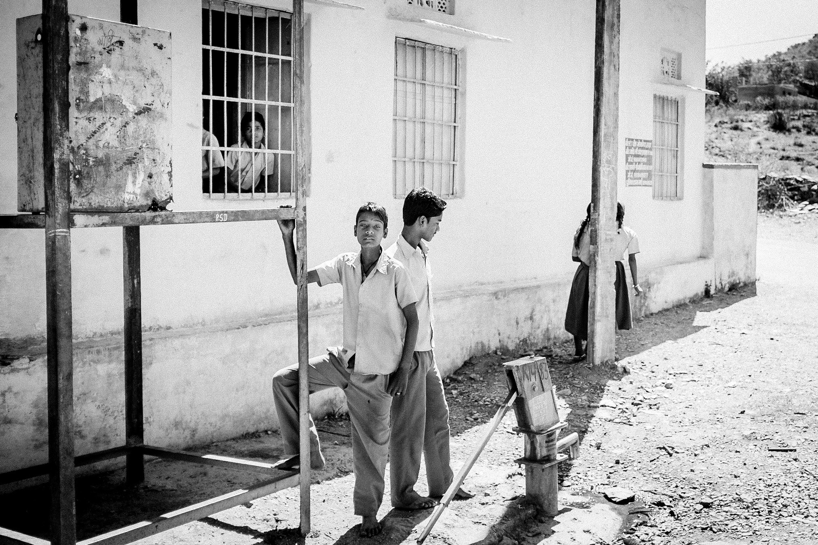 a couple of men standing next to each other near a building