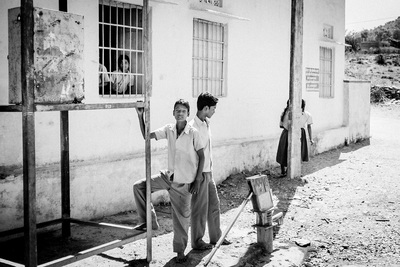 a couple of men standing next to each other near a building