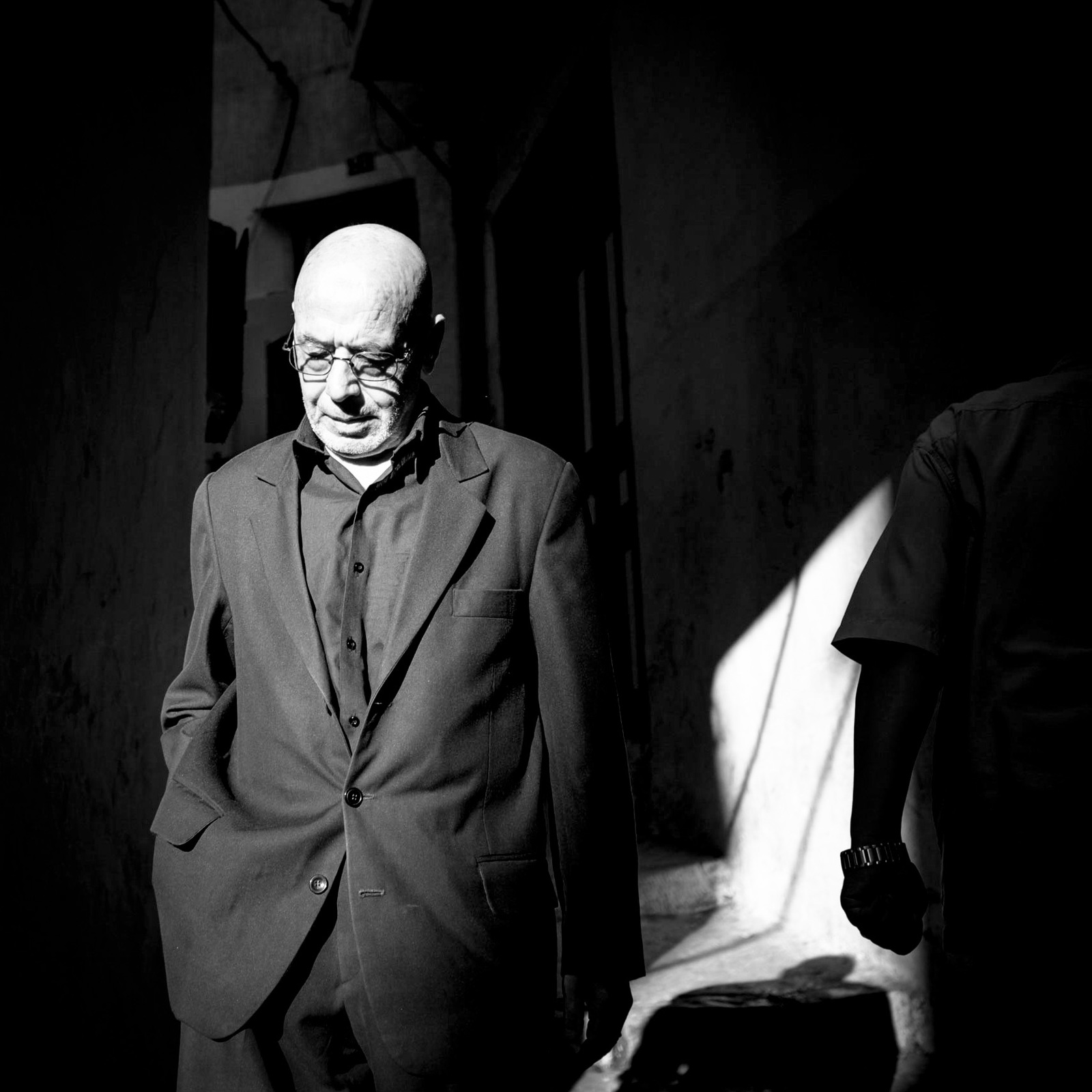 a black and white photo of a man in a suit