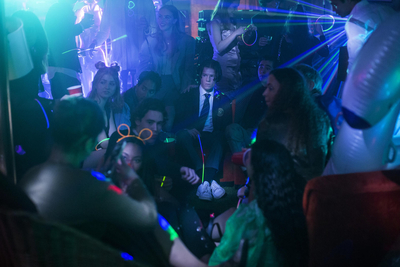 a group of people sitting in a room at a party