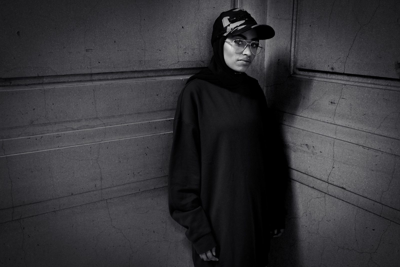 a black and white photo of a woman wearing a hat