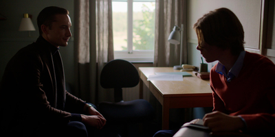 a man sitting next to a woman in a living room