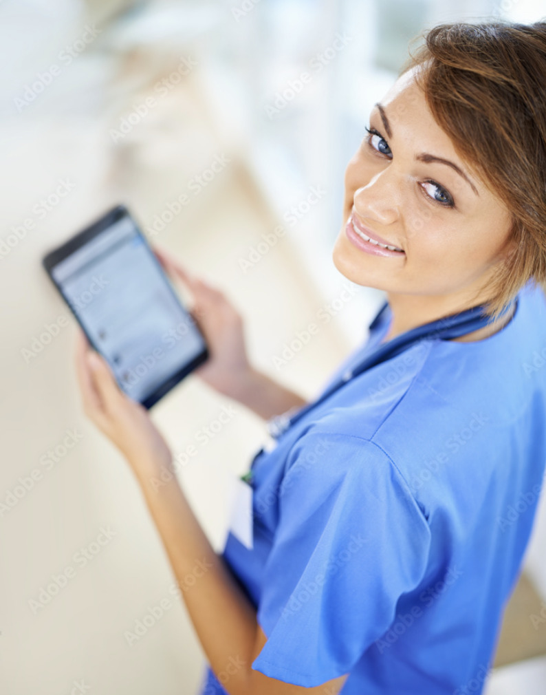 a woman in scrubs is holding a tablet