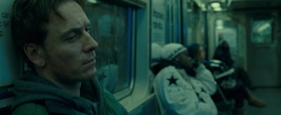 a man looking out the window of a subway car