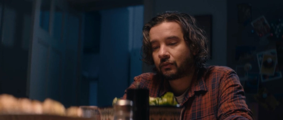 a man sitting at a table with a glass in front of him