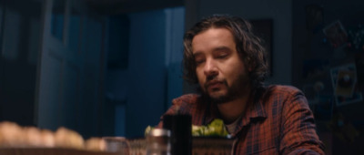 a man sitting at a table with a glass in front of him