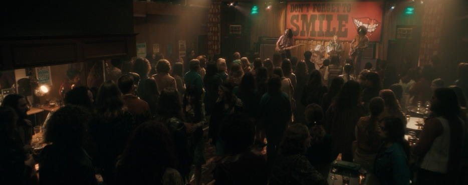 a crowd of people standing around a bar