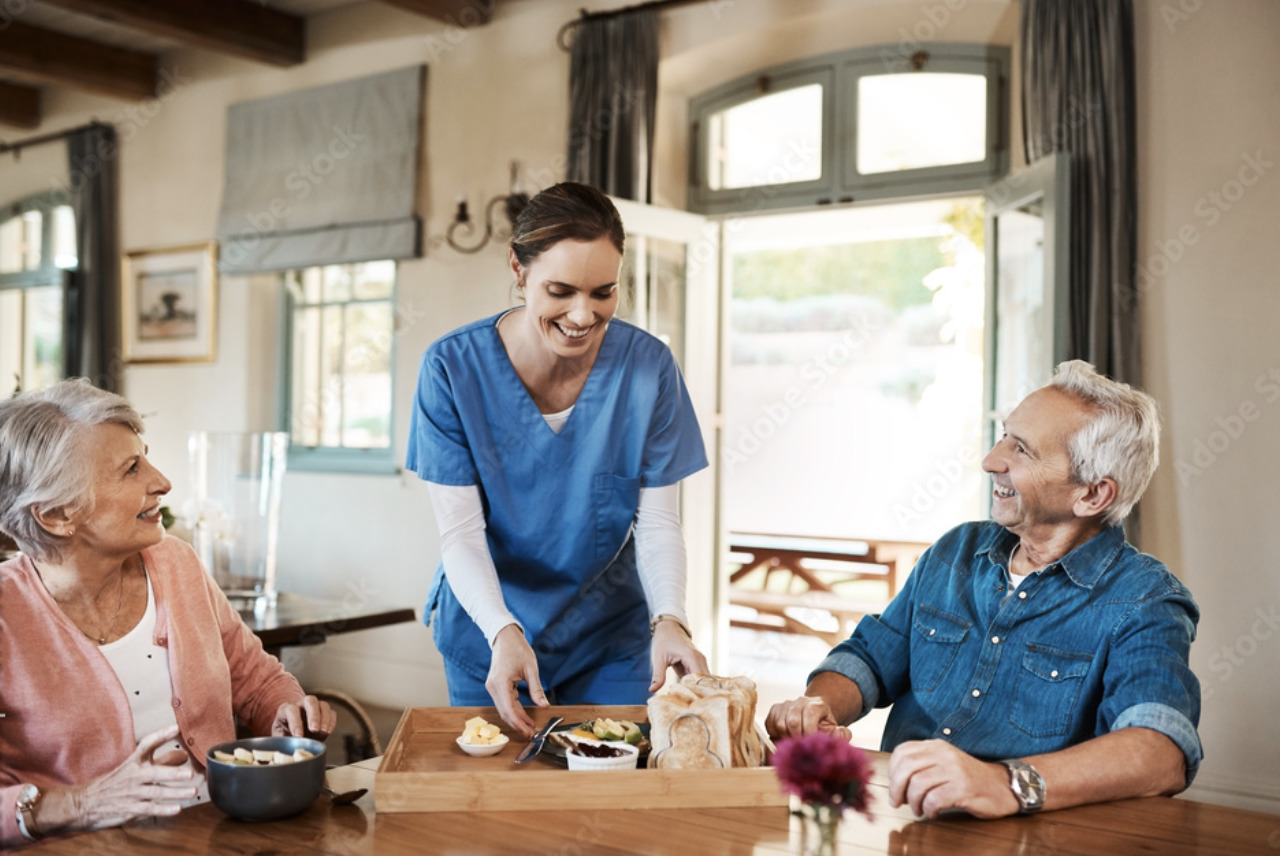 a group of people sitting around a wooden table