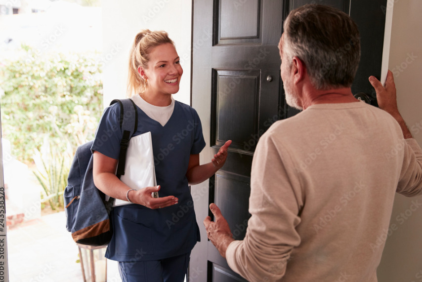 a woman talking to a man in front of a door