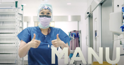 a woman wearing a surgical mask giving a thumbs up