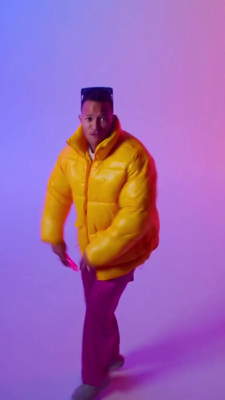 a man in a yellow jacket and purple pants