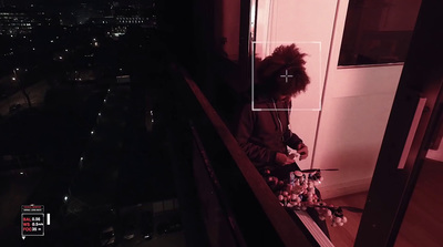 a person sitting on a window sill at night