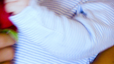 a close up of a person wearing a striped shirt