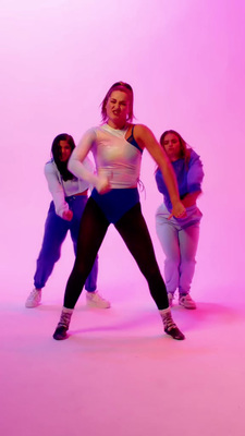 a group of young women standing around each other