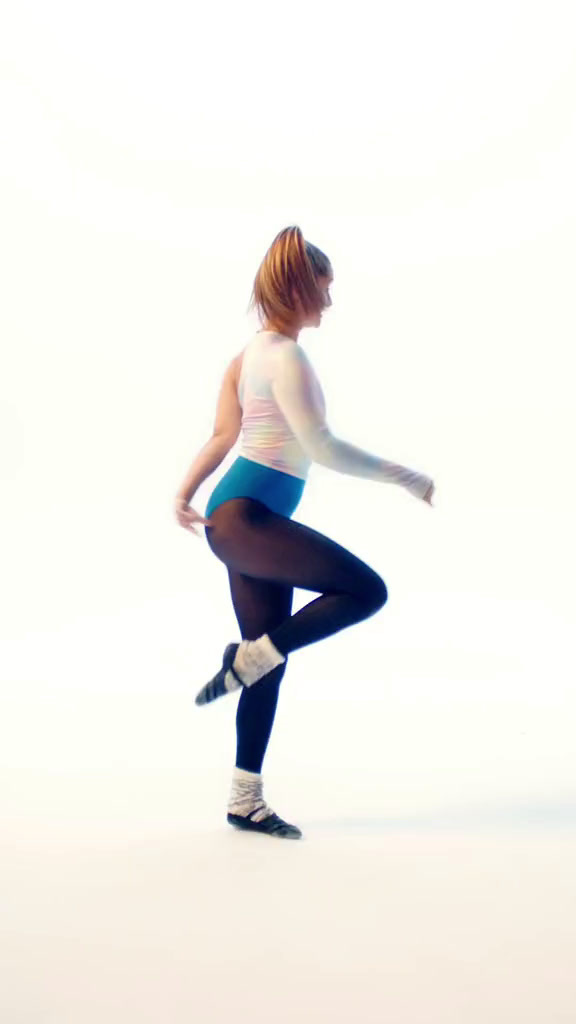 a woman in tights and boots is doing a dance move