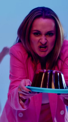 a woman holding a cake on a blue plate