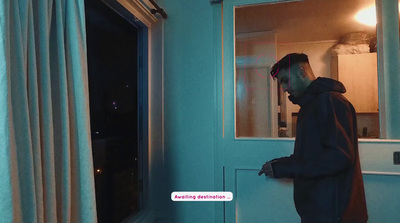 a man standing in front of a window next to a curtain