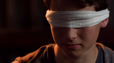 a young boy with a bandage on his head