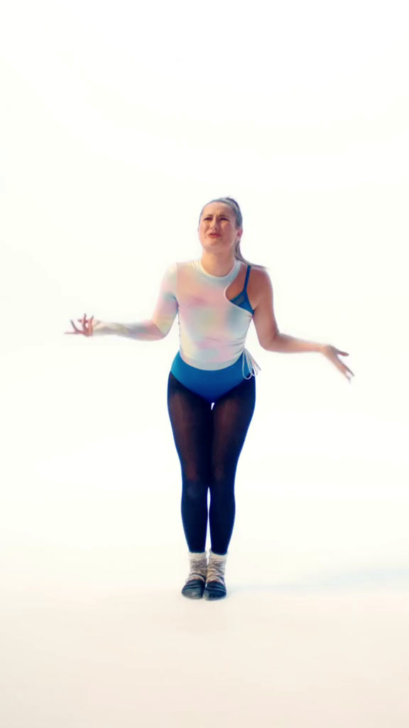 a woman in a white tank top and black tights