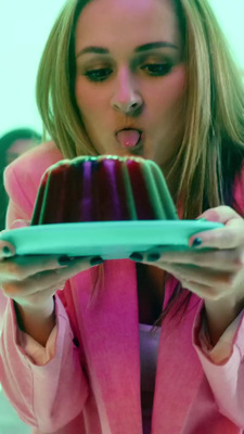 a woman holding a plate with a cake on it