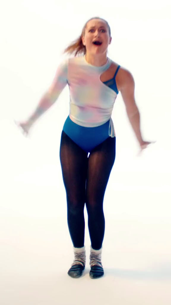 a woman in a blue and white leotard