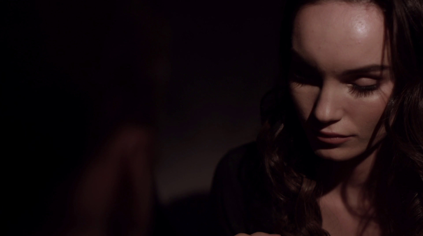 a woman holding a cell phone in a dark room