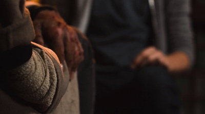 a close up of a person's hand on a couch