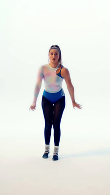 a woman in a blue and white tank top and black leggings