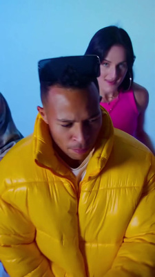 a man in a yellow jacket looking at a cell phone