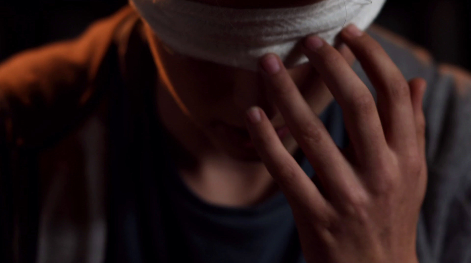 a close up of a person holding a doughnut to their face