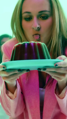 a woman holding a plate with a cake on it