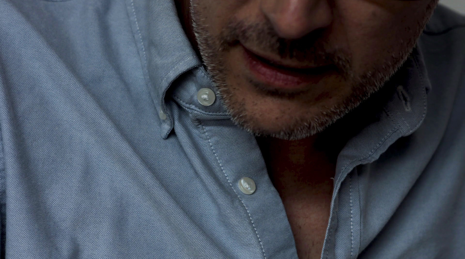 a close up of a person wearing a blue shirt