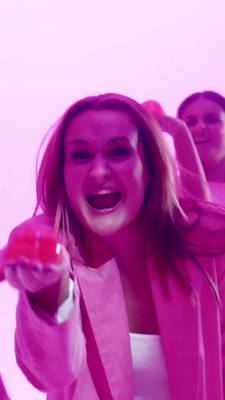 a woman holding a red apple in her right hand