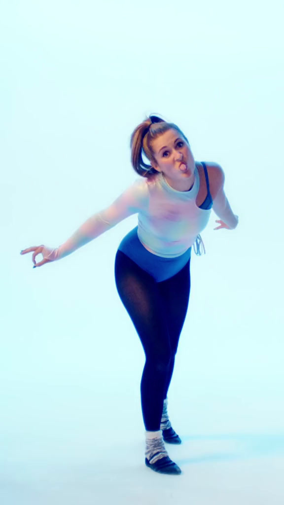 a woman in tights and a tank top is dancing