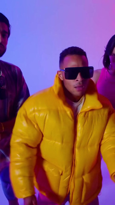 a man wearing a yellow jacket and sunglasses