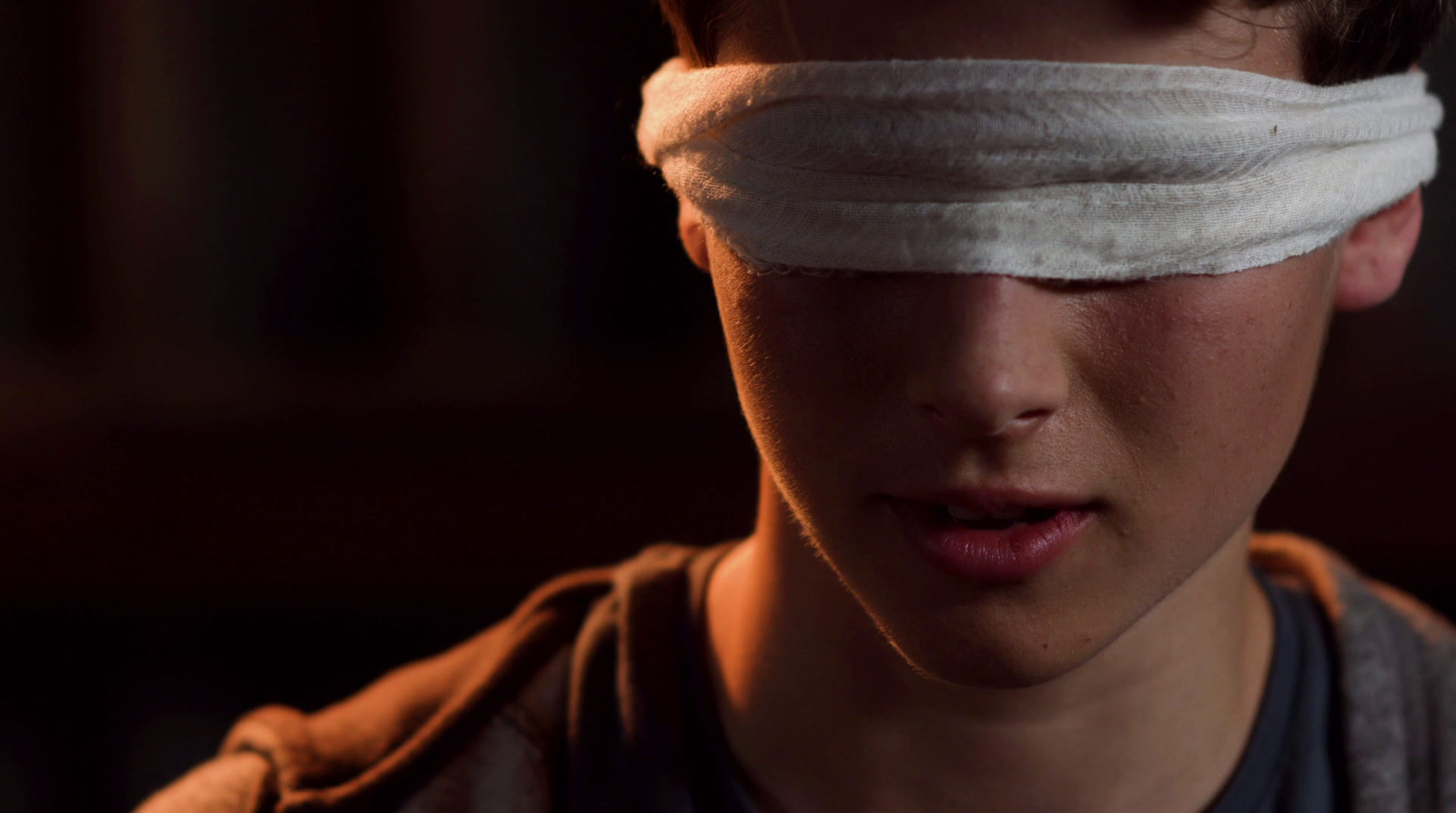 a young boy with a bandage on his forehead