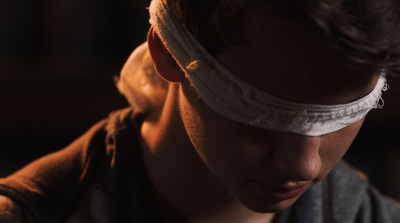 a young man with a blindfold on his head