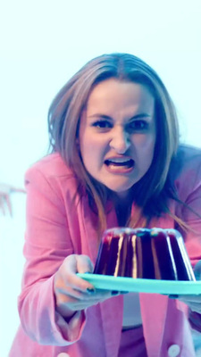 a woman holding a plate with a cake on it