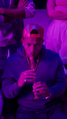 a man in a red hat is playing a trumpet