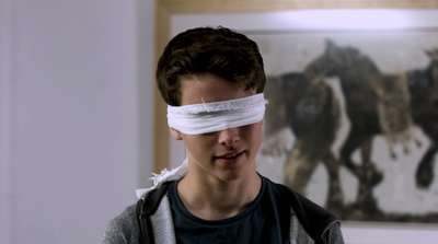 a boy with a blindfold on his face