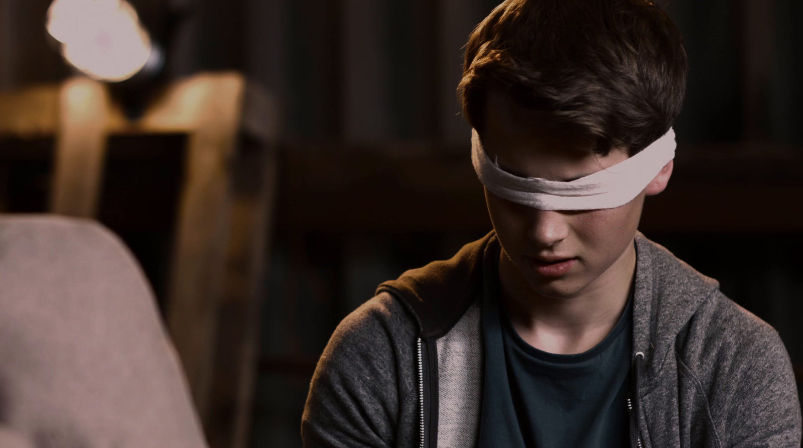 a young man with a blindfold around his head