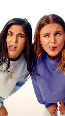 two women are making faces while posing for a picture