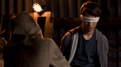 a young man with a blindfold on his head