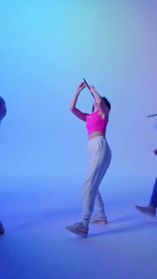 a woman in a pink top is dancing