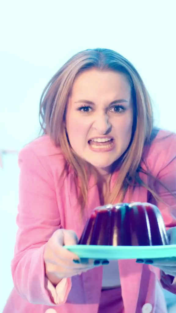 a woman holding a plate with a cake on it