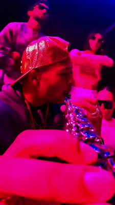 a man in a red hat is playing a saxophone