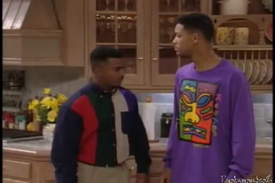 two men standing in a kitchen talking to each other