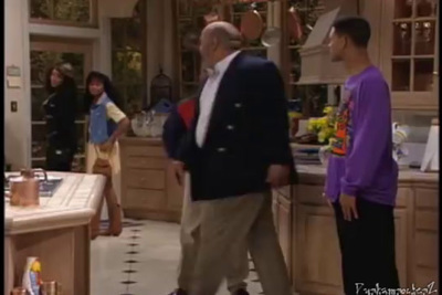 a group of people standing around a kitchen