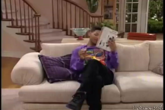 a person sitting on a couch reading a book